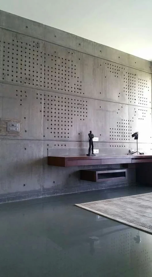 Perforated pattern wall with floating steel shelf
