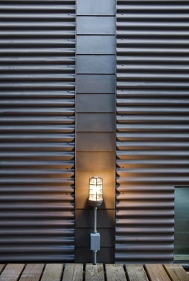 Corrugated wall panel with light fixture