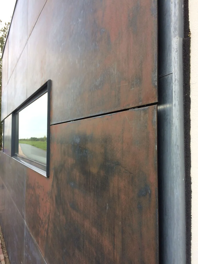 Weathering steel facade panels with a ribbon window