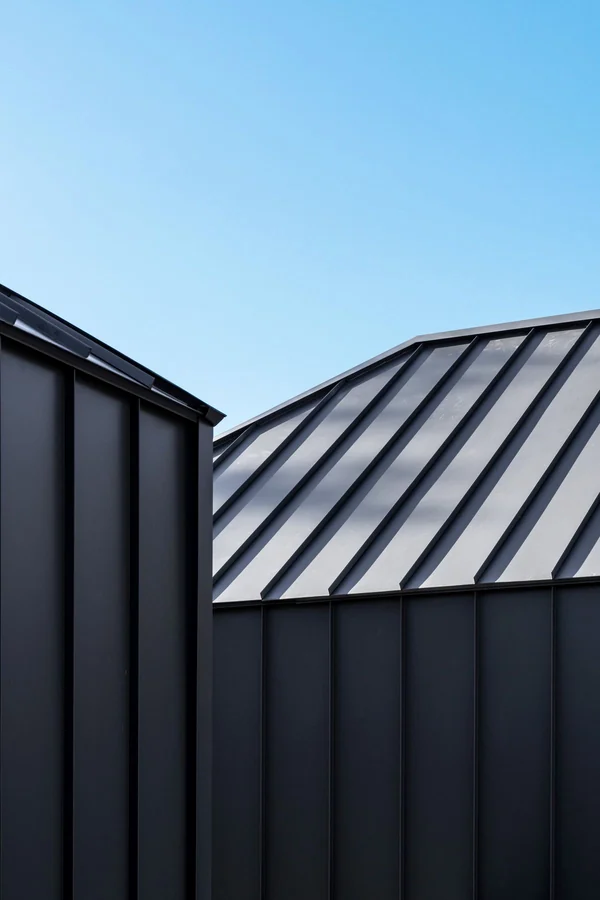 Standing seam metal roof and dark cladding